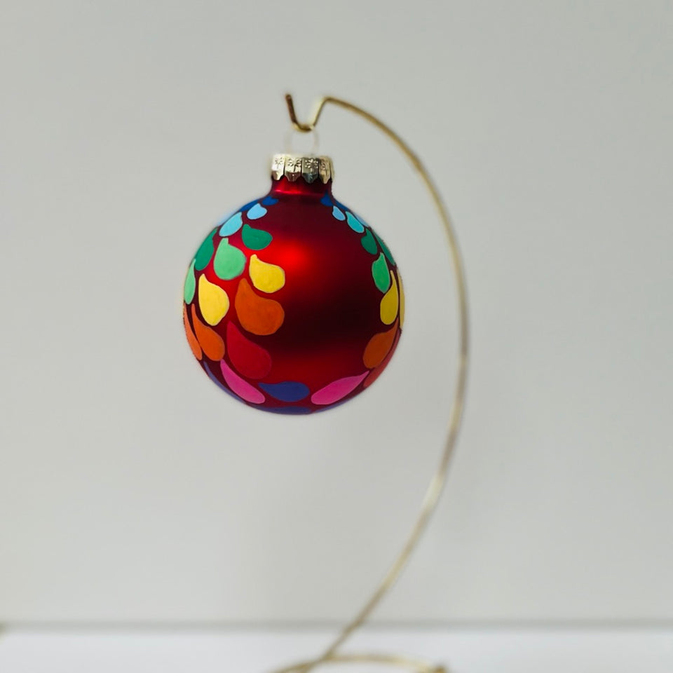 Red Glass Ornament with Hand-Painted Rainbow Gradient Design