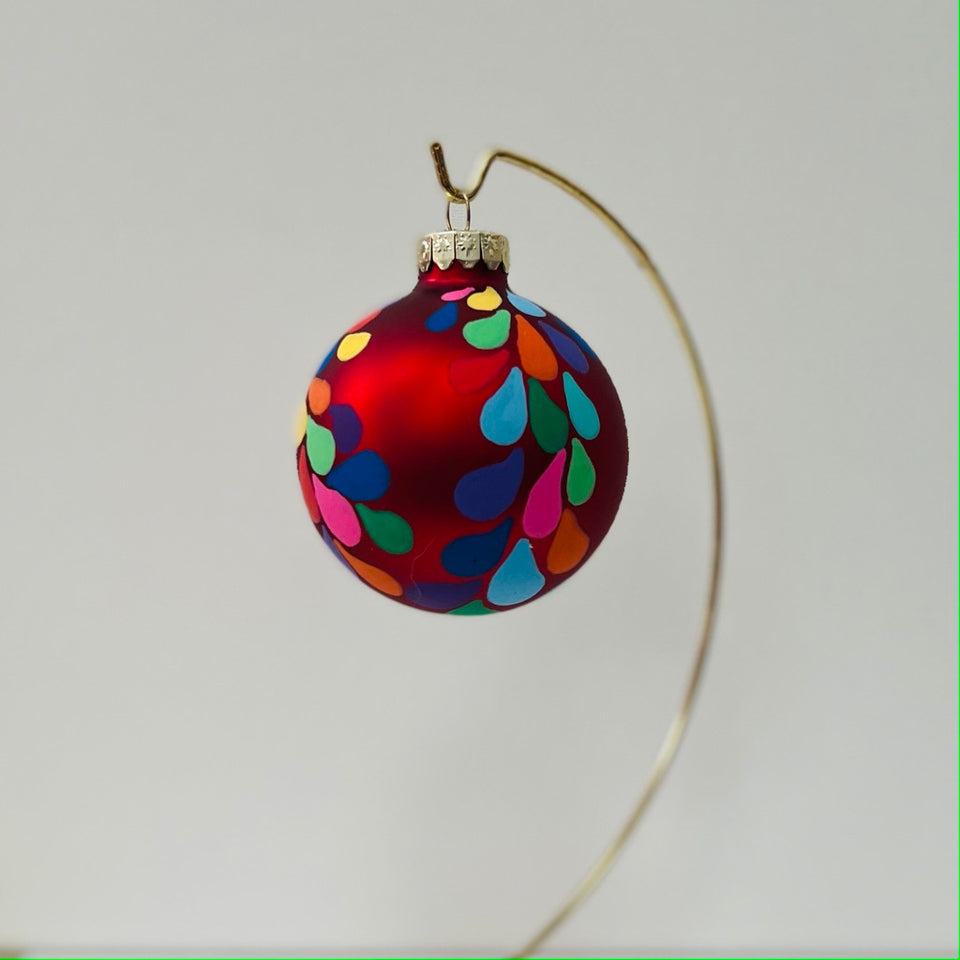 Red Glass Ornament with Hand-Painted Rainbow Design