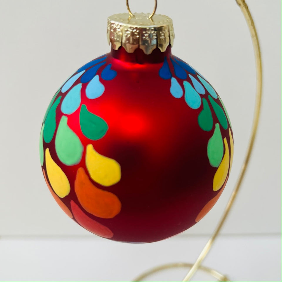 Red Glass Ornament with Hand-Painted Rainbow Gradient Design