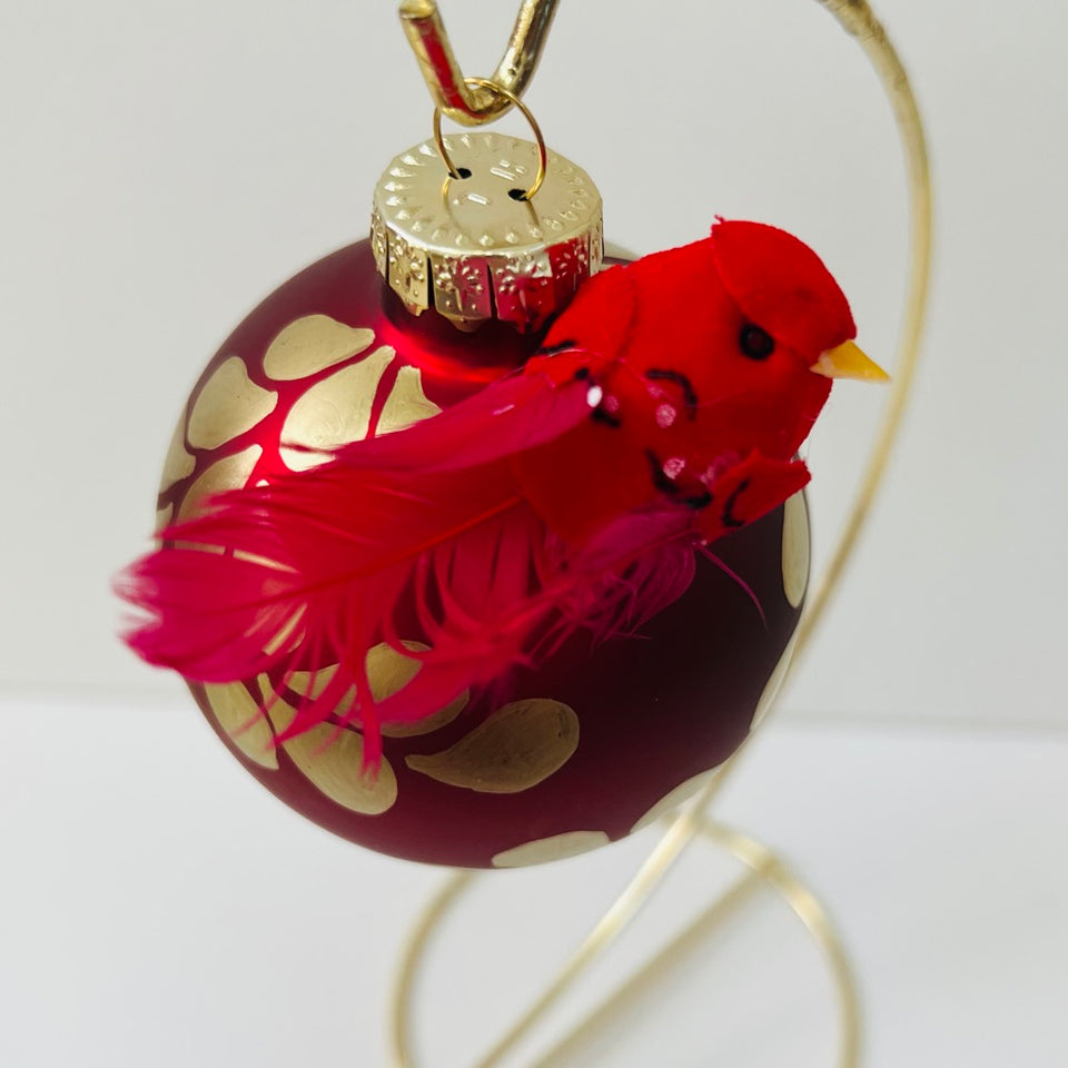 Red Glass Ornament with Hand-Painted Gold Design and Cardinal Accent